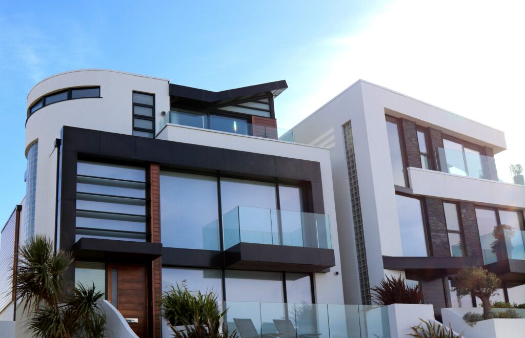 A modern house with glass balconies and a large balcony.